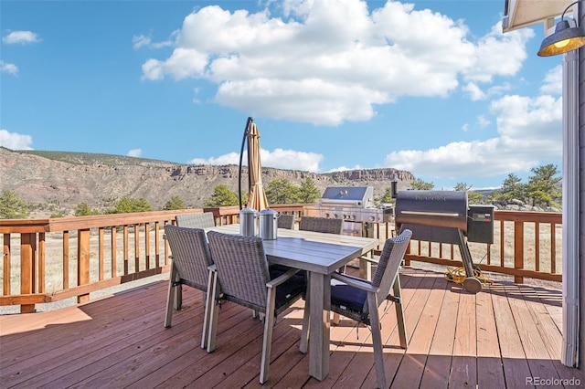 700 Apple Ridge Rd, Lyons, CO 80540 - deck with outdoor dining space, a mountain view, a grill, and an outdoor kitchen
