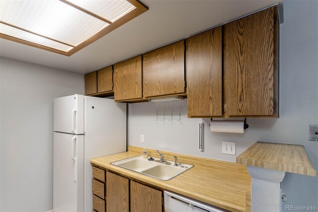 kitchen with white appliances and sink