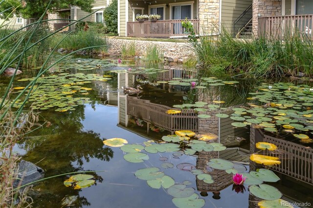 view of community with a small pond