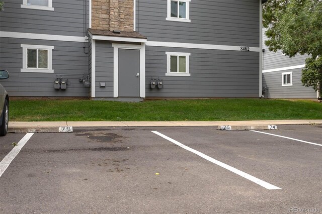 view of vehicle parking with a yard