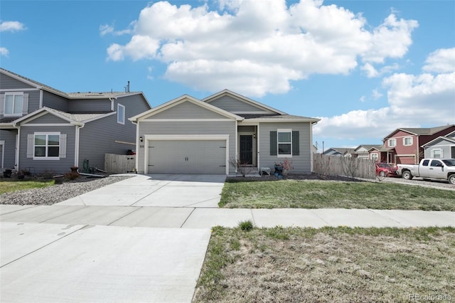 310 Quincy Rr Ave, Keenesburg, CO 80643 - view of front of home featuring an attached garage, a front lawn, driveway, and fence