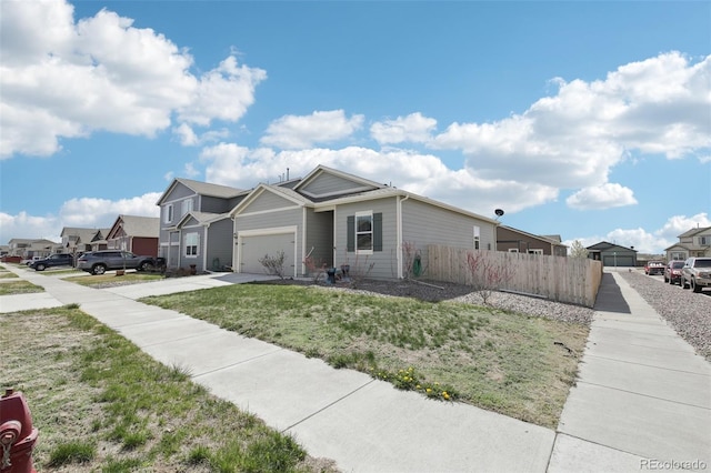 310 Quincy Rr Ave, Keenesburg, CO 80643 - view of front of house with concrete driveway, a front lawn, fence, a garage, and a residential view