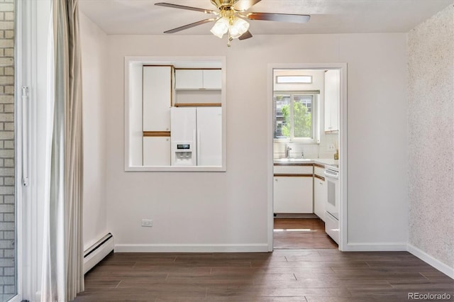 7801 W 35th Ave Unit 1, Wheat Ridge, CO 80033 - spare room featuring a baseboard heating unit, dark wood-type flooring, and a ceiling fan