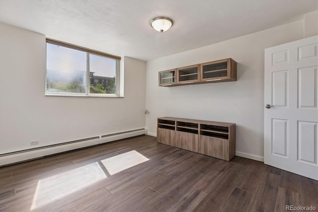7801 W 35th Ave Unit 1, Wheat Ridge, CO 80033 - spare room with a baseboard heating unit and dark wood-type flooring