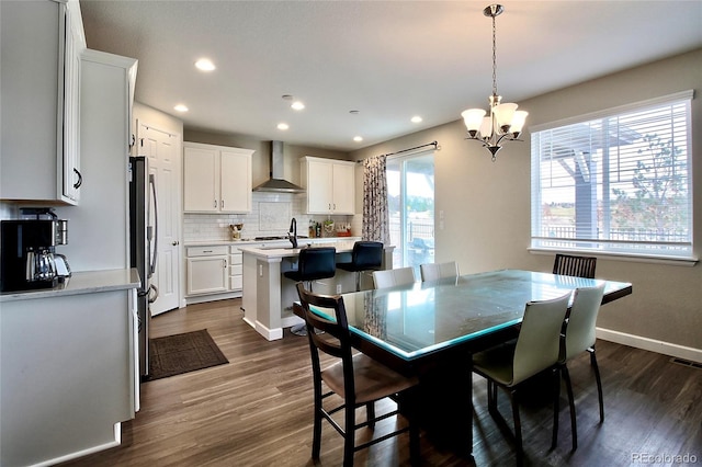 dining area with visible vents, dark wood-style flooring, baseboards, recessed lighting, and a chandelier