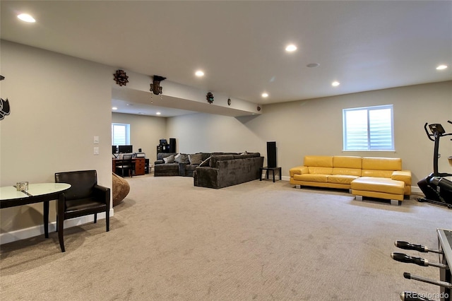 carpeted living area featuring recessed lighting, baseboards, and plenty of natural light
