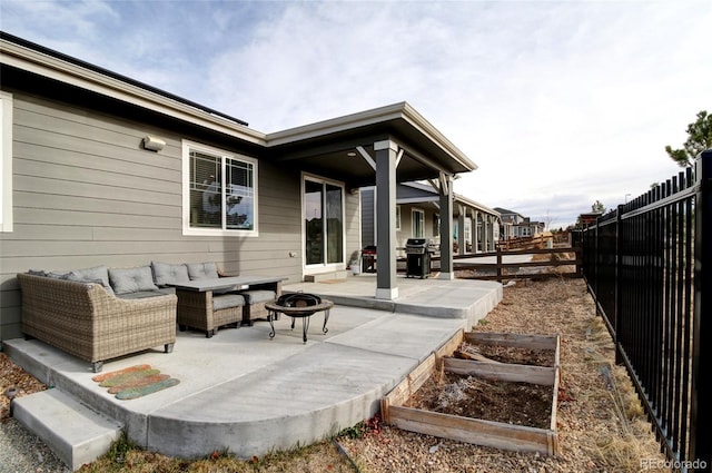 view of patio with a fenced backyard, an outdoor living space with a fire pit, a garden, and grilling area