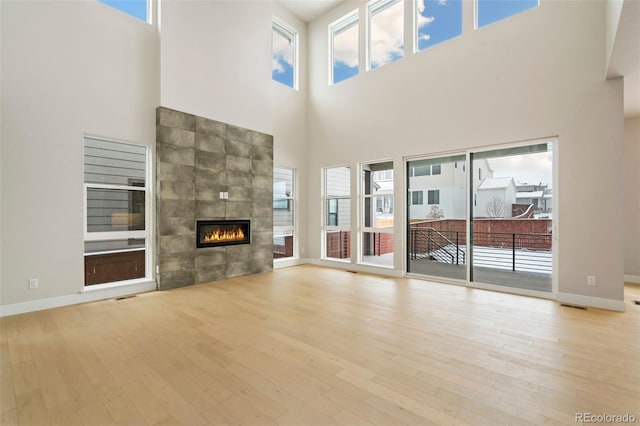 unfurnished living room featuring plenty of natural light and light wood-type flooring