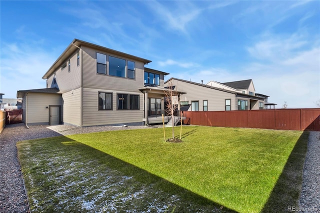 rear view of house featuring a yard