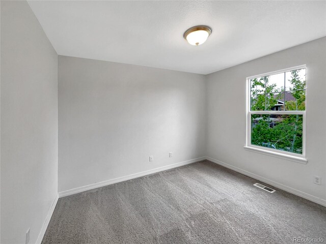 carpeted empty room with baseboards and visible vents
