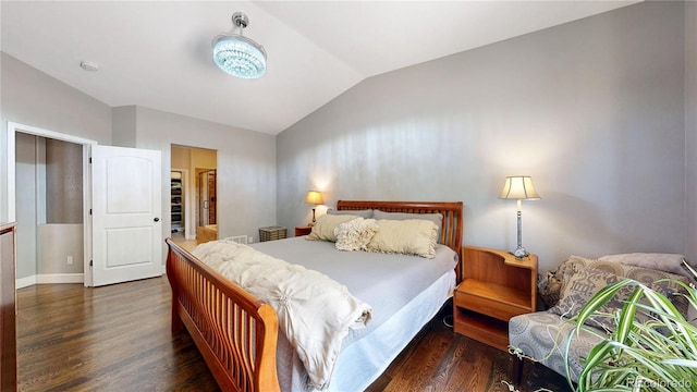 6945 Fargo Trl, Littleton, CO 80125 - bedroom featuring vaulted ceiling and wood finished floors