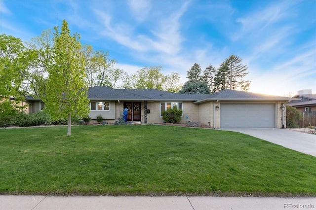 ranch-style home featuring a garage, concrete driveway, brick siding, and a front lawn