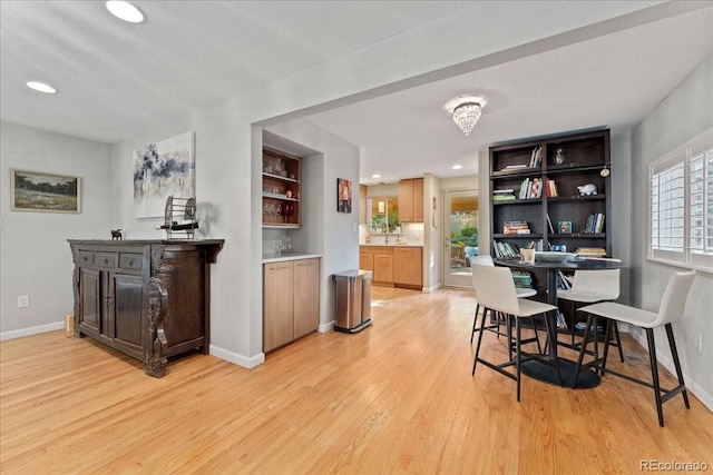 dining room with light wood-type flooring, baseboards, and recessed lighting