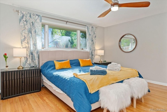 bedroom featuring ceiling fan, baseboards, and wood finished floors