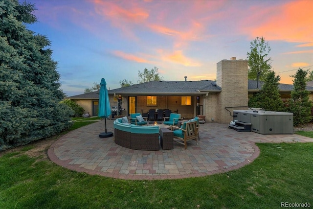 back of house featuring a patio area, a hot tub, an outdoor living space, and brick siding