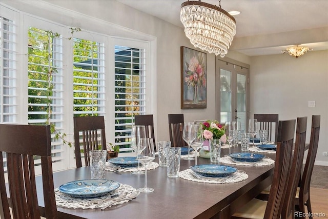 dining room with baseboards and a notable chandelier