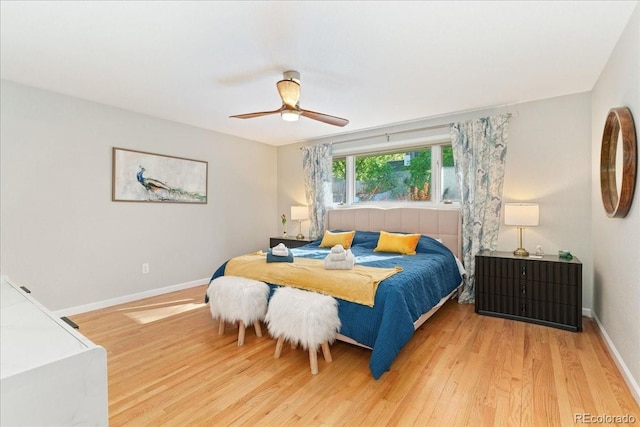 bedroom featuring ceiling fan, baseboards, and wood finished floors