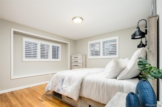 bedroom featuring baseboards and wood finished floors