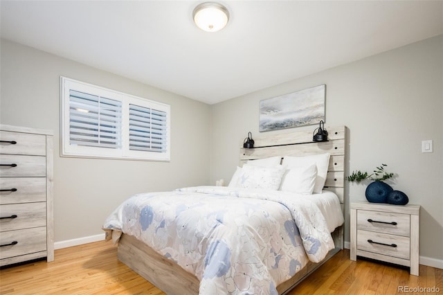 bedroom featuring light wood-type flooring and baseboards