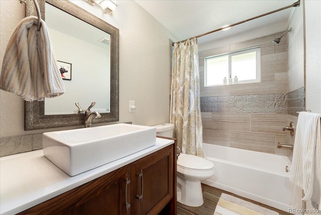 bathroom with visible vents, toilet, wood finished floors, shower / bathtub combination with curtain, and vanity