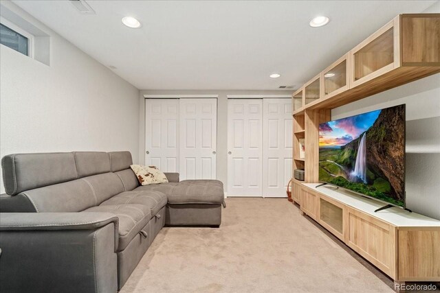 living area featuring recessed lighting, light carpet, and visible vents