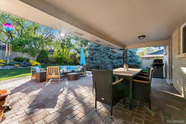 view of patio / terrace with a grill, outdoor dining area, a fenced backyard, and an outdoor living space with a fire pit