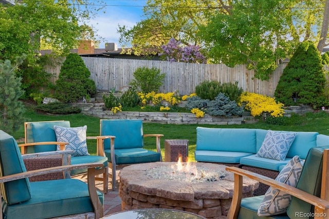 view of patio / terrace featuring an outdoor living space with a fire pit and fence