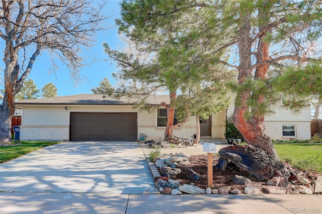 ranch-style house featuring concrete driveway, brick siding, and an attached garage