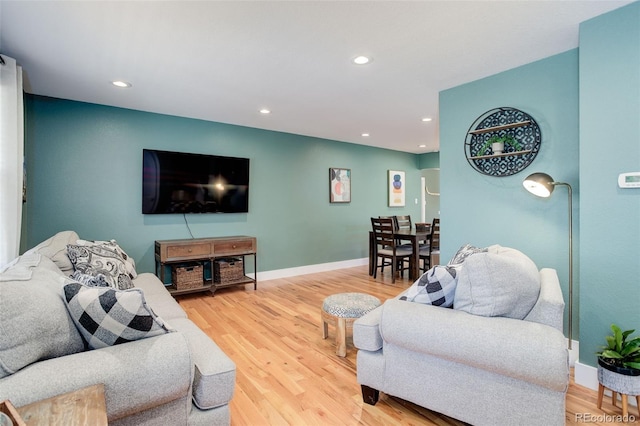 living area featuring recessed lighting, baseboards, and wood finished floors