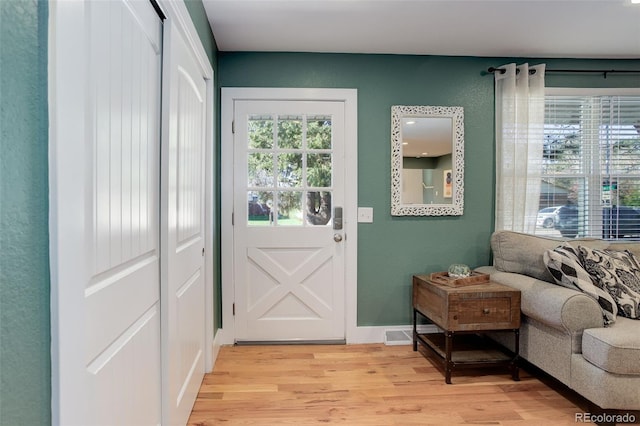 doorway with light wood finished floors