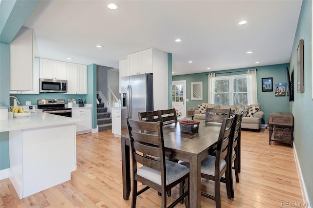 dining room featuring stairs, recessed lighting, and light wood-type flooring
