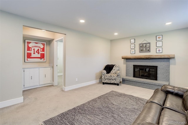 carpeted living area featuring a brick fireplace, recessed lighting, and baseboards