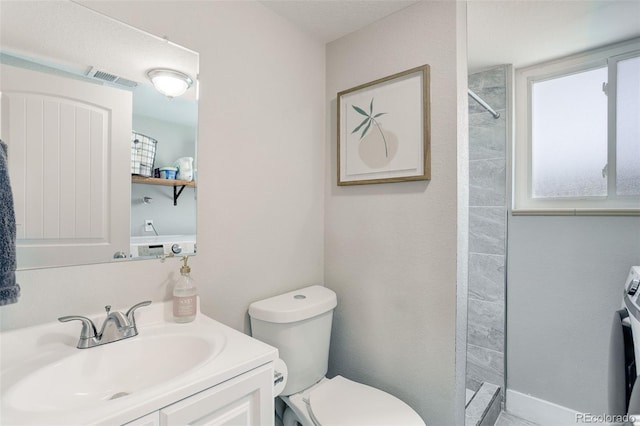 bathroom featuring visible vents, a tile shower, toilet, and vanity