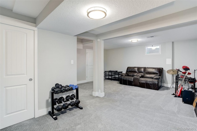 interior space featuring carpet floors, a textured ceiling, baseboards, and visible vents