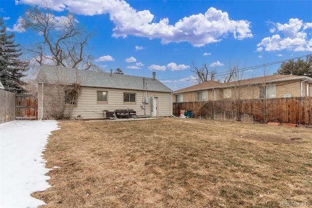 back of property with a patio area, fence, and a lawn