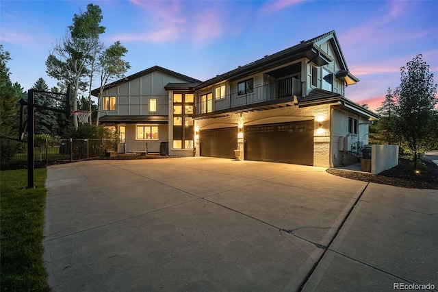 view of front of home featuring a balcony and a garage