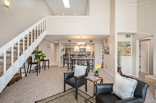 23585 Genesee Village Rd Unit E, Golden, CO 80401 - living area with a towering ceiling, light carpet, stairway, a chandelier, and recessed lighting