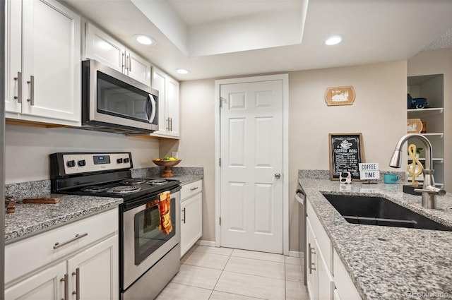 23585 Genesee Village Rd Unit E, Golden, CO 80401 - kitchen featuring stainless steel appliances, white cabinetry, light stone counters, light tile patterned flooring, and recessed lighting