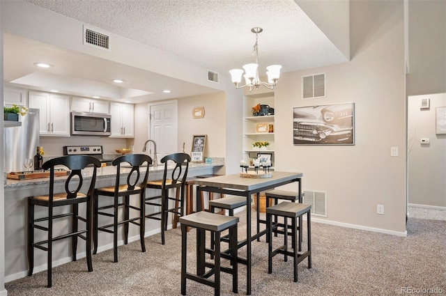 23585 Genesee Village Rd Unit E, Golden, CO 80401 - dining area featuring a chandelier, light carpet, a textured ceiling, and recessed lighting