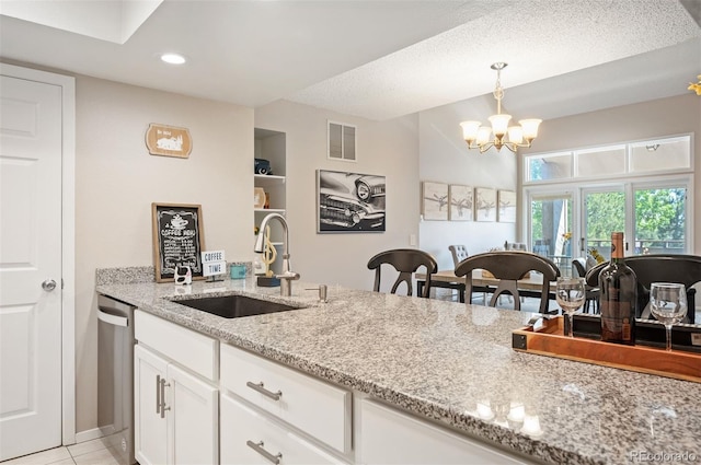 23585 Genesee Village Rd Unit E, Golden, CO 80401 - kitchen with dishwasher, light stone counters, white cabinetry, hanging light fixtures, and a chandelier