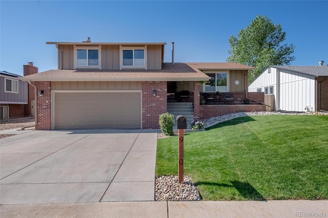 9700 W 88th Pl, Westminster, CO 80021 - tri-level home featuring board and batten siding, brick siding, driveway, and a front lawn