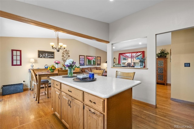 9700 W 88th Pl, Westminster, CO 80021 - kitchen featuring light wood-style floors, a center island, a chandelier, light countertops, and baseboards