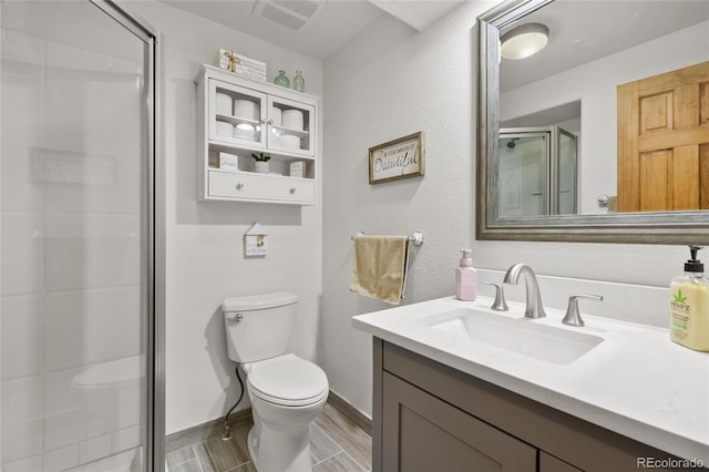 9700 W 88th Pl, Westminster, CO 80021 - full bathroom featuring toilet, a stall shower, wood finished floors, vanity, and baseboards