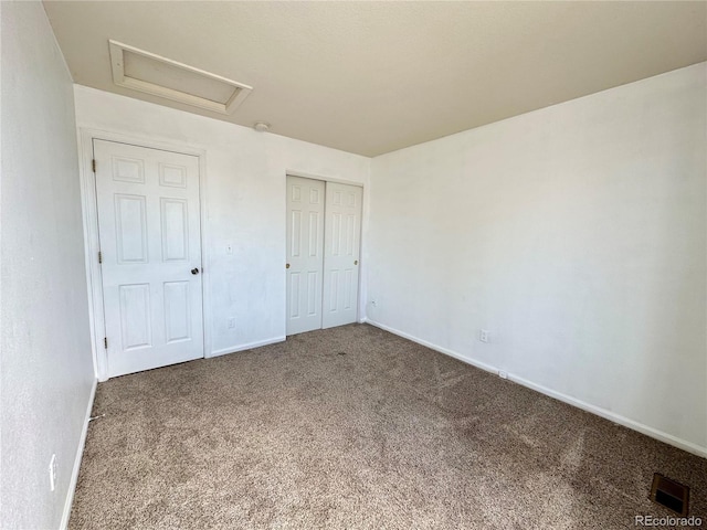 2033 Espana Way, Aurora, CO 80011 - unfurnished bedroom featuring attic access, carpet, baseboards, and a closet