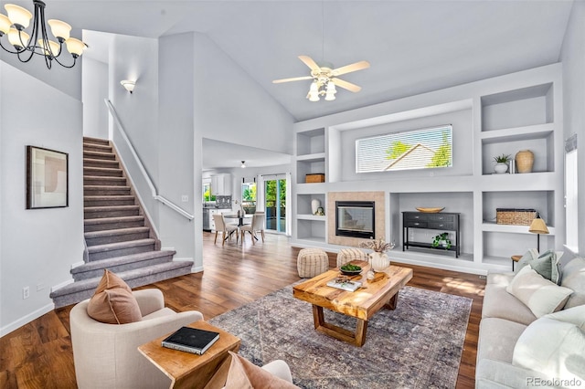 14712 Josephine St, Thornton, CO 80602 - living room with built in shelves, stairs, high vaulted ceiling, wood finished floors, and a chandelier