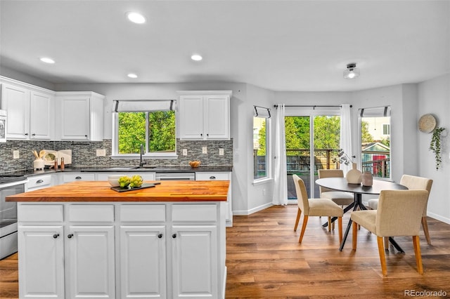 14712 Josephine St, Thornton, CO 80602 - kitchen with wooden counters, white cabinetry, backsplash, stainless steel appliances, and recessed lighting