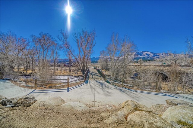 view of yard featuring fence and a mountain view