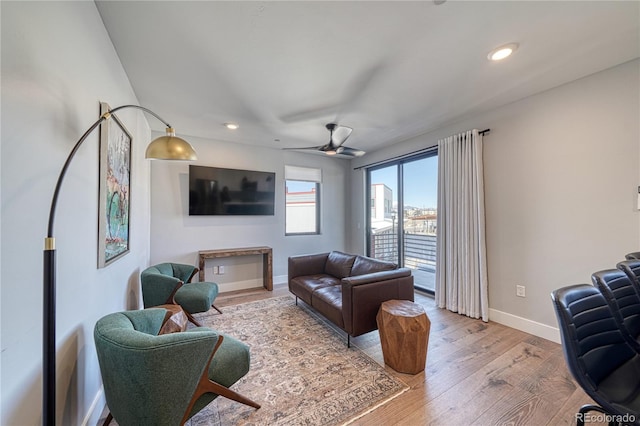 living room with recessed lighting, ceiling fan, light wood-style flooring, and baseboards