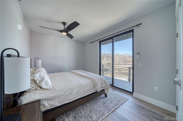 bedroom with baseboards, ceiling fan, wood finished floors, and access to exterior