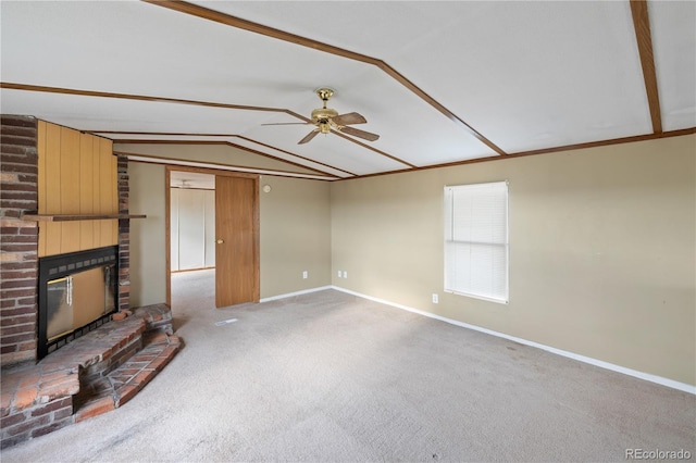 35275 Book Rd, Yoder, CO 80864 - unfurnished living room featuring vaulted ceiling, a ceiling fan, a brick fireplace, baseboards, and carpet floors